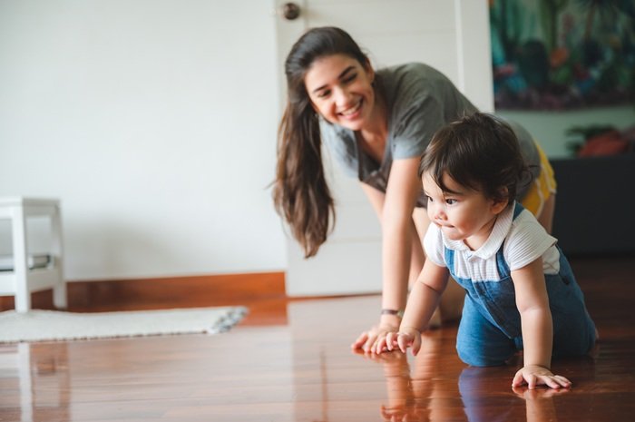 little toddler children with first walk step with stairs at home, small baby person are happy to play and learn to crawling with family, cute infant boy having fun and childhood care